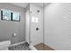 Modern bathroom featuring a walk-in shower with white tile and glass enclosure at 9422 E Southwind Ln, Scottsdale, AZ 85262