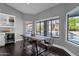 Dining room with large windows overlooking the pool and lush landscaping at 9422 E Southwind Ln, Scottsdale, AZ 85262