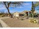 Inviting home showcasing manicured desert landscaping, a three-car garage, and tile roof at 9422 E Southwind Ln, Scottsdale, AZ 85262
