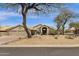Charming single-story home featuring desert landscaping, tile roof, and a welcoming entryway at 9422 E Southwind Ln, Scottsdale, AZ 85262