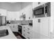 Bright kitchen featuring white cabinets, stainless steel appliances, and dark hardware at 9422 E Southwind Ln, Scottsdale, AZ 85262