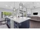 Open concept kitchen with large island, pendant lighting, and seamless flow to living area at 9422 E Southwind Ln, Scottsdale, AZ 85262