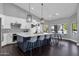 Modern kitchen featuring a center island with bar seating and stainless steel appliances at 9422 E Southwind Ln, Scottsdale, AZ 85262