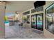 Covered patio with outdoor dining area, built-in grill, and seamless indoor-outdoor living at 9422 E Southwind Ln, Scottsdale, AZ 85262