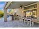 Covered patio features an outdoor dining space with a built-in grill, and lush landscaping at 9422 E Southwind Ln, Scottsdale, AZ 85262