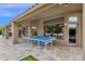 A covered outdoor patio with a ping pong table and recessed lighting at 9422 E Southwind Ln, Scottsdale, AZ 85262