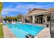 Resort-style pool with luxurious lounge chairs, outdoor grilling area and covered patio at 9422 E Southwind Ln, Scottsdale, AZ 85262