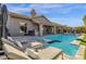 An in-ground swimming pool with lounge chairs and backyard view at 9422 E Southwind Ln, Scottsdale, AZ 85262