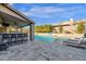 A large swimming pool with lounge chairs, bar, and a basketball hoop in the backyard at 9422 E Southwind Ln, Scottsdale, AZ 85262