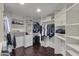Large walk-in closet with custom shelving, drawers, and organized storage solutions at 9422 E Southwind Ln, Scottsdale, AZ 85262