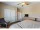 Comfortable bedroom featuring a ceiling fan, TV, closet, and neutral color scheme, creating a relaxing atmosphere at 9535 E Los Lagos Vista Ave, Mesa, AZ 85209