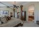 A luxurious main bedroom with a four-poster bed, offering ample closet space and a view of the ensuite bathroom at 9535 E Los Lagos Vista Ave, Mesa, AZ 85209