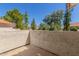 Private balcony featuring stucco walls, neutral flooring and views of mature trees at 9705 E Mountain View Rd # 1064, Scottsdale, AZ 85258