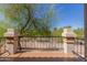 Private balcony with black metal railing and views of mature trees at 9705 E Mountain View Rd # 1064, Scottsdale, AZ 85258