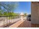 Private balcony with black metal railing and views of mature trees at 9705 E Mountain View Rd # 1064, Scottsdale, AZ 85258