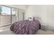 Bright bedroom with a full-size bed and sliding glass doors to a private balcony at 9705 E Mountain View Rd # 1064, Scottsdale, AZ 85258