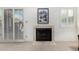 Close-up of a fireplace with tiled surround and plantation shutters at 9705 E Mountain View Rd # 1064, Scottsdale, AZ 85258