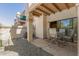 Relaxing outdoor patio with stone flooring, desert landscaping and seating at 9705 E Mountain View Rd # 1064, Scottsdale, AZ 85258