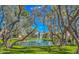 Scenic pond featuring a fountain, lush greenery, and mature trees in a serene community setting at 9705 E Mountain View Rd # 1064, Scottsdale, AZ 85258