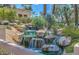 Cascading waterfall surrounded by lush greenery and rocks, adding a tranquil element to the community at 9705 E Mountain View Rd # 1064, Scottsdale, AZ 85258