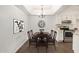 Traditional dining room with wooden table, chairs, chandelier, and stainless steel appliances at 10610 S 48Th St # 1068, Phoenix, AZ 85044