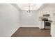 Dining room adjacent to kitchen with an elegant chandelier and stainless steel appliances at 10610 S 48Th St # 1068, Phoenix, AZ 85044