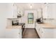 Well-lit kitchen with white cabinetry, neutral countertops, stainless steel appliances, and a window at 10610 S 48Th St # 1068, Phoenix, AZ 85044