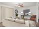 Bright living room featuring a ceiling fan, modern furnishings, and large windows for natural light at 10610 S 48Th St # 1068, Phoenix, AZ 85044