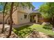 Charming backyard with lush greenery, a covered patio for entertaining, and a well-maintained lawn at 12030 W Polk St, Avondale, AZ 85323