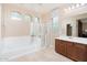 Luxurious bathroom featuring a soaking tub, separate shower, and vanity with sink at 12030 W Polk St, Avondale, AZ 85323
