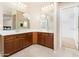 Bright bathroom with double sinks, vanity, and view to the closet and shower at 12030 W Polk St, Avondale, AZ 85323