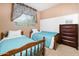 Polka dot themed bedroom with two twin beds, small window and dresser at 12030 W Polk St, Avondale, AZ 85323