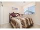 Serene bedroom with a plush bed, lamp, neutral walls, and a bright window at 12030 W Polk St, Avondale, AZ 85323