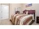 Comfortable bedroom featuring a plush bed, mirrored closet, and neutral decor for a relaxing ambiance at 12030 W Polk St, Avondale, AZ 85323