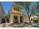 Two-story home features a stucco facade, two-car garage and covered porch with an arched entryway at 12030 W Polk St, Avondale, AZ 85323