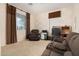 Cozy living room with neutral carpet, stone accent wall, and ample seating at 12030 W Polk St, Avondale, AZ 85323