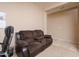 This living room features neutral carpet and a plush sofa, creating a comfortable and inviting space at 12030 W Polk St, Avondale, AZ 85323