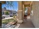 Covered porch features concrete flooring, stucco columns, and a seating area to enjoy the outdoors at 12030 W Polk St, Avondale, AZ 85323