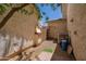 Functional side yard with gravel, leading to a backyard entry door at 12030 W Polk St, Avondale, AZ 85323