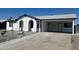 Single-story home with carport, xeriscaped front yard, and fresh white paint with black trim at 13202 N 40Th Pl, Phoenix, AZ 85032