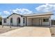 Single-story home showcasing an extended driveway, carport, neutral paint, and a well-kept desert yard at 13202 N 40Th Pl, Phoenix, AZ 85032