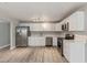 Well-lit kitchen featuring stainless steel appliances, white cabinets, and wood-look flooring at 13202 N 40Th Pl, Phoenix, AZ 85032