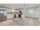 Modern kitchen with stainless steel appliances, white cabinetry, and wood-look flooring at 13202 N 40Th Pl, Phoenix, AZ 85032