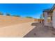 View of a spacious backyard with a block wall, patio, and barbecue area, ready for outdoor enjoyment at 14188 W Artemisa Ave, Surprise, AZ 85387