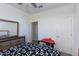 Bedroom with a dresser and mirror along with adjacent doors to other rooms and closets at 14188 W Artemisa Ave, Surprise, AZ 85387