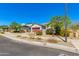 Suburban home with a red garage door, desert landscaping, and ample street parking under a cloudless blue sky at 14188 W Artemisa Ave, Surprise, AZ 85387