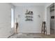 Stylish foyer with decorative shelving, neutral decor, and wood-look tile flooring at 14188 W Artemisa Ave, Surprise, AZ 85387