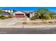 Charming single-story home with a red garage door, neutral stucco, and desert landscaping under a clear blue sky at 14188 W Artemisa Ave, Surprise, AZ 85387
