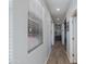 Bright hallway featuring tile flooring, recessed lighting, and access to various rooms at 14188 W Artemisa Ave, Surprise, AZ 85387