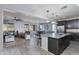 Open concept living space features a kitchen, dining area, and living room at 14188 W Artemisa Ave, Surprise, AZ 85387